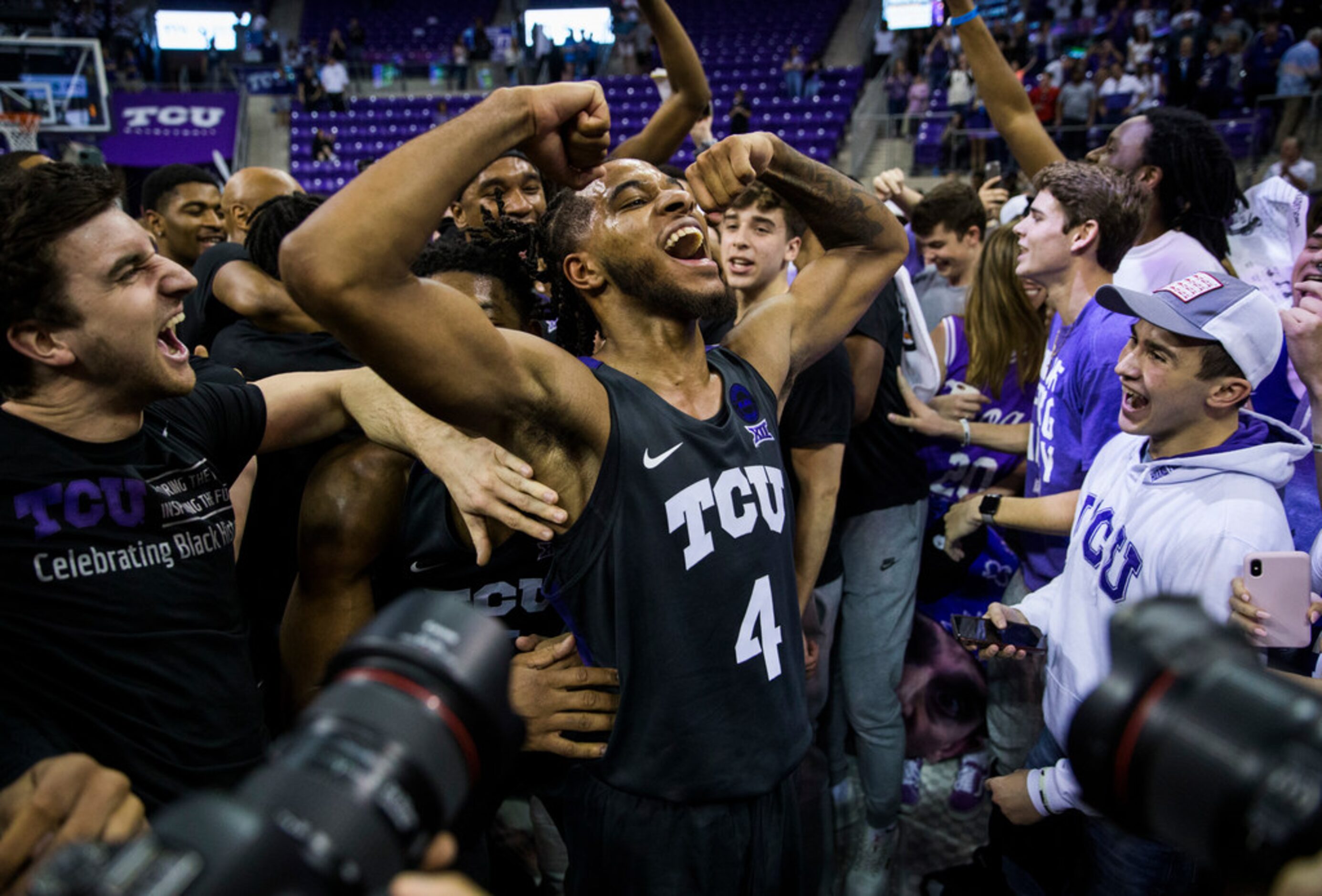 TCU Horned Frogs guard PJ Fuller (4) celebrates after fans rush the court because of a 75-72...