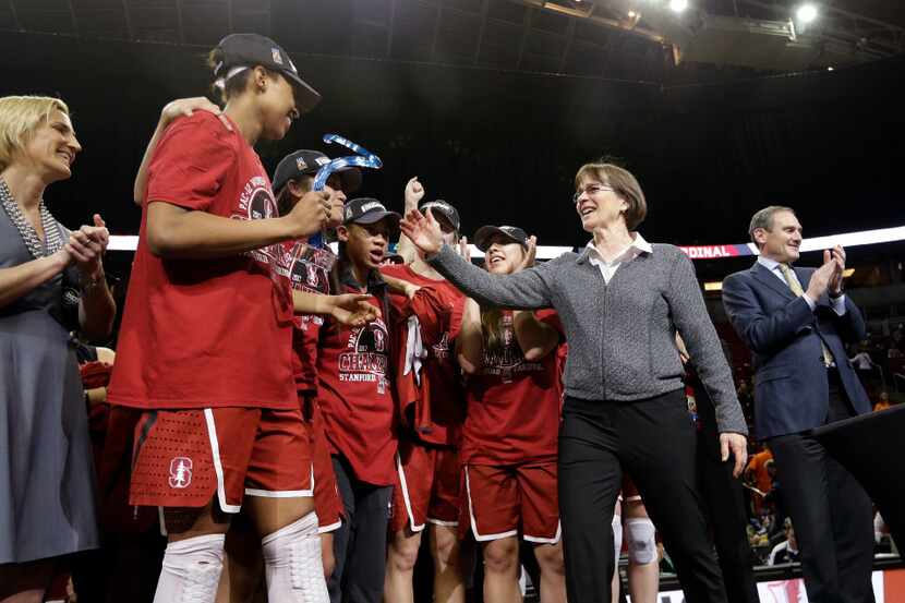 Stanford's Erica McCall holds her tournament most outstanding player award and is...