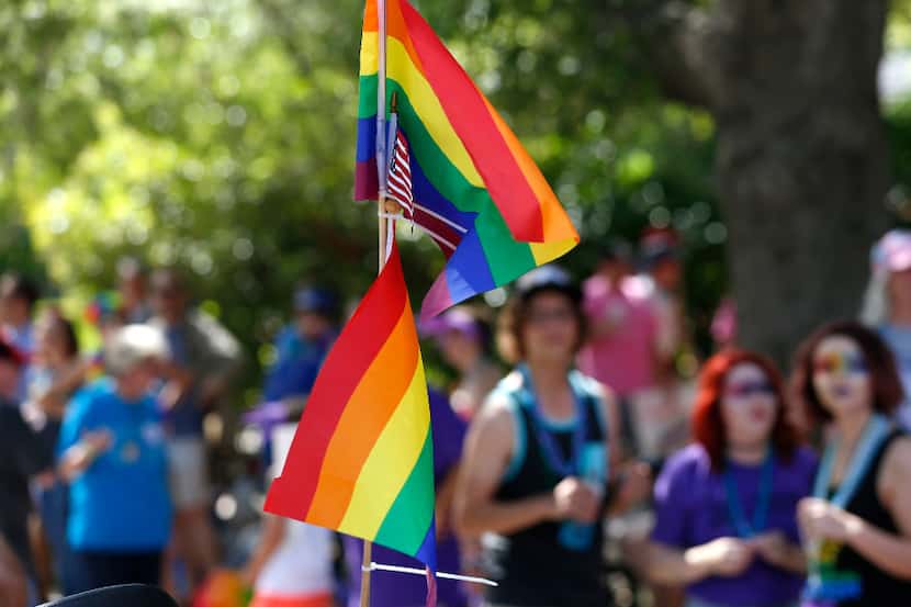 Rainbow flags and an American flag fly at Dallas' LGBT pride parade on Turtle Creek...