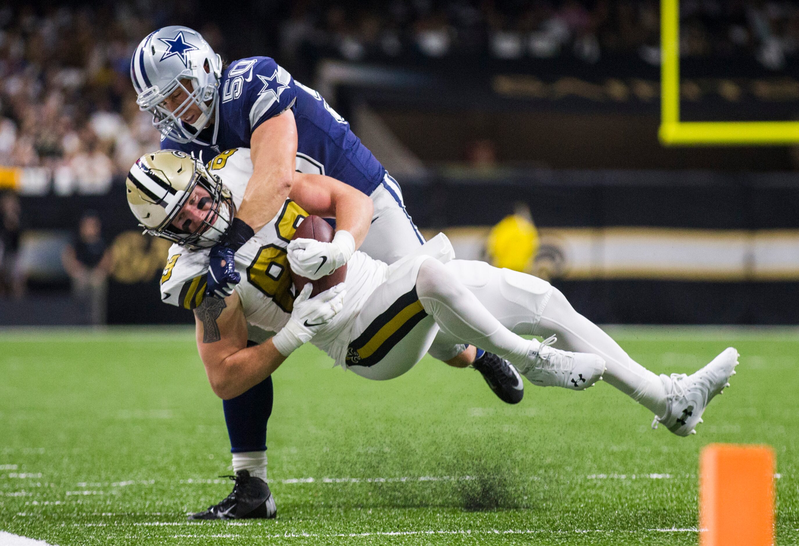 Dallas Cowboys outside linebacker Sean Lee (50) tackles New Orleans Saints tight end Josh...