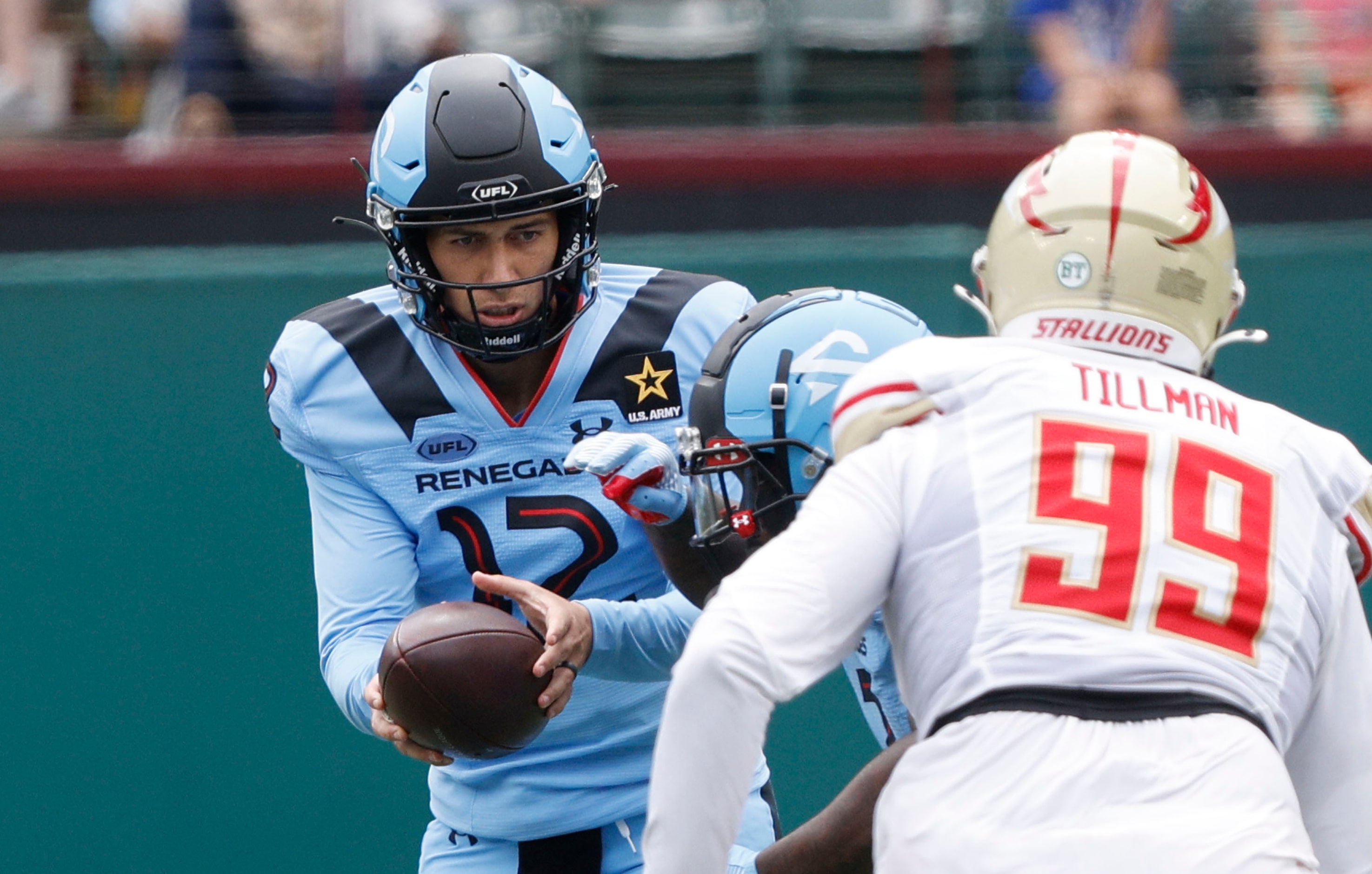 Arlington Renegades quarterback Luis Perez (12) hands off to Arlington Renegades running...