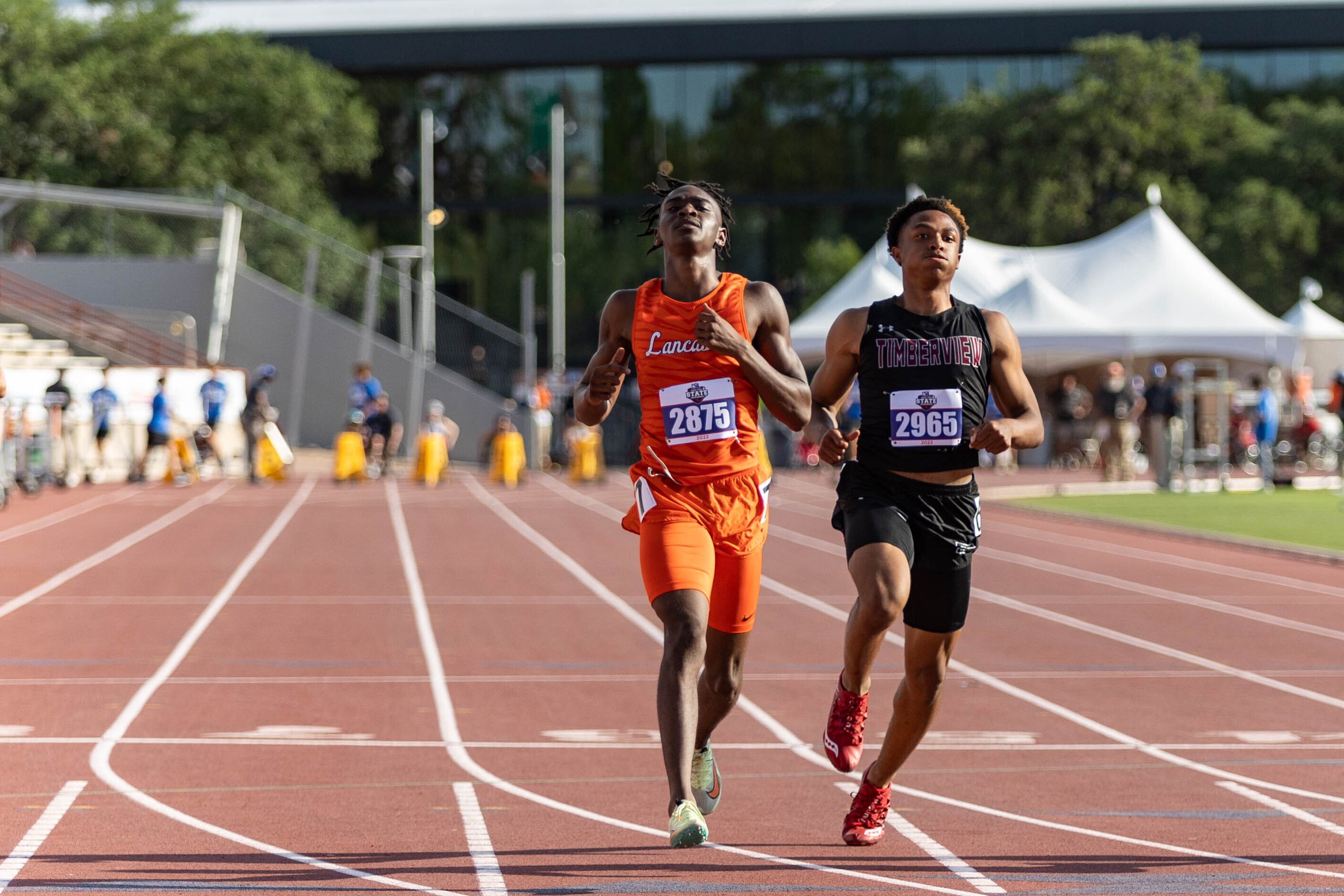 Lancaster’s Kordarion Smith and Mansfield Timberview’s Jordan Sanford react after crossing...