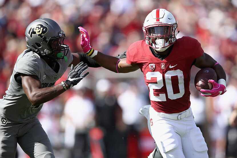 PALO ALTO, CA - OCTOBER 22:  Bryce Love #20 of the Stanford Cardinal tries to run away from...