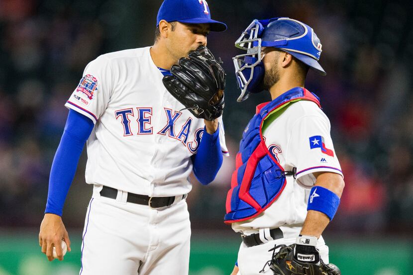 Texas Rangers relief pitcher Jeanmar Gomez (46) chats with catcher Isiah Kiner-Falefa (9) on...