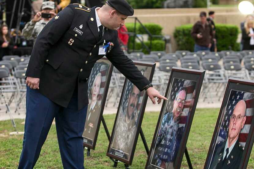 
Purple Heart recipient Pfc. James Armstrong touches the image of Capt. John Gaffaney, who...