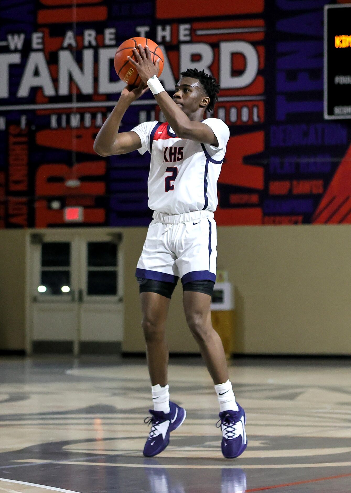 Kimball guard T'Johnn Brown (2) attempts a three point shot against Woodrow Wilson during...