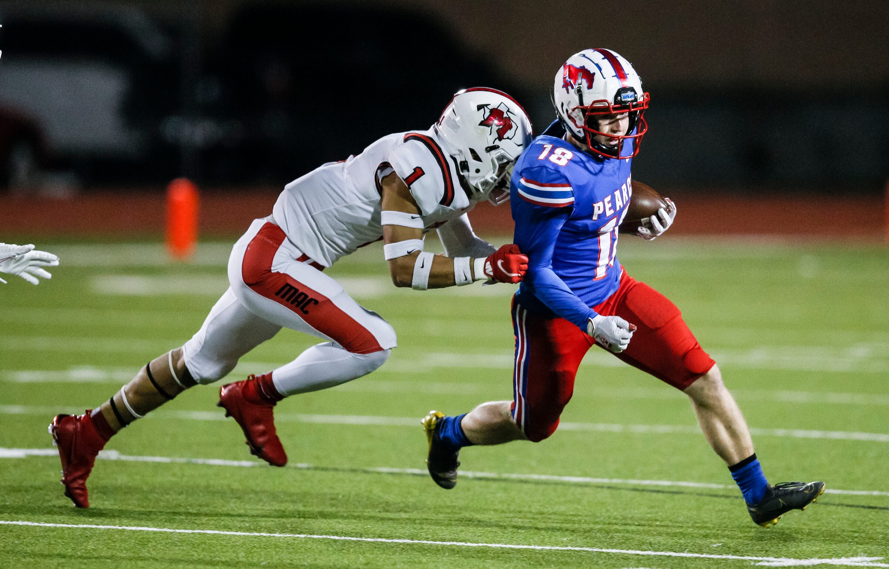 Irving MacArthur senior Roland Jackson (1) tackles JJ Pearce junior running back Adam Velin...