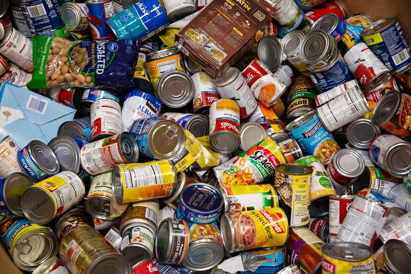 A crate of canned foods awaits sorting and packing at Crossroads Community Services...