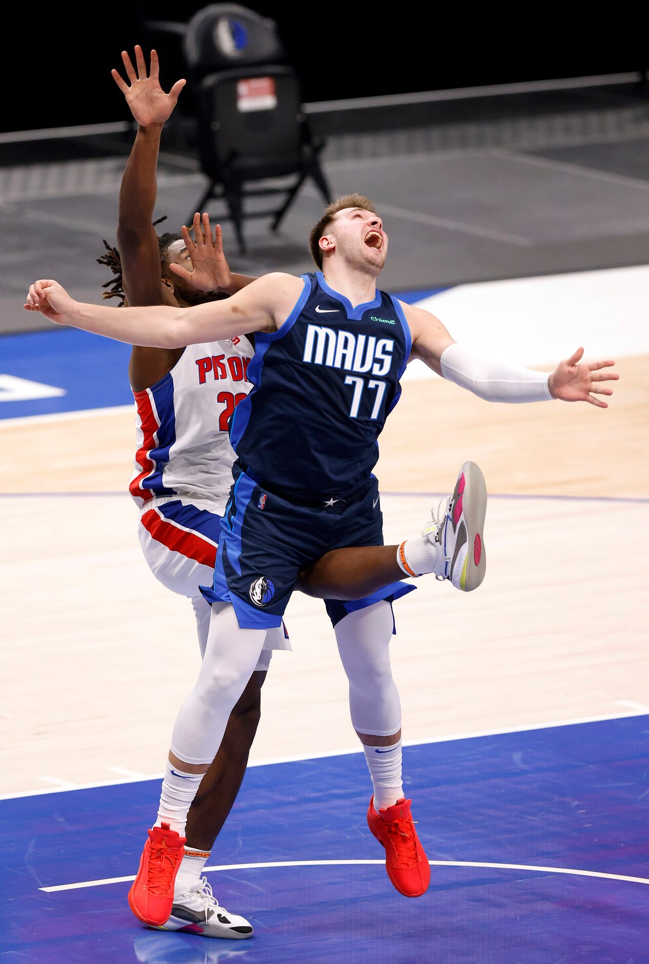 Dallas Mavericks guard Luka Doncic (77) receives a kick to the groin after driving the lane...