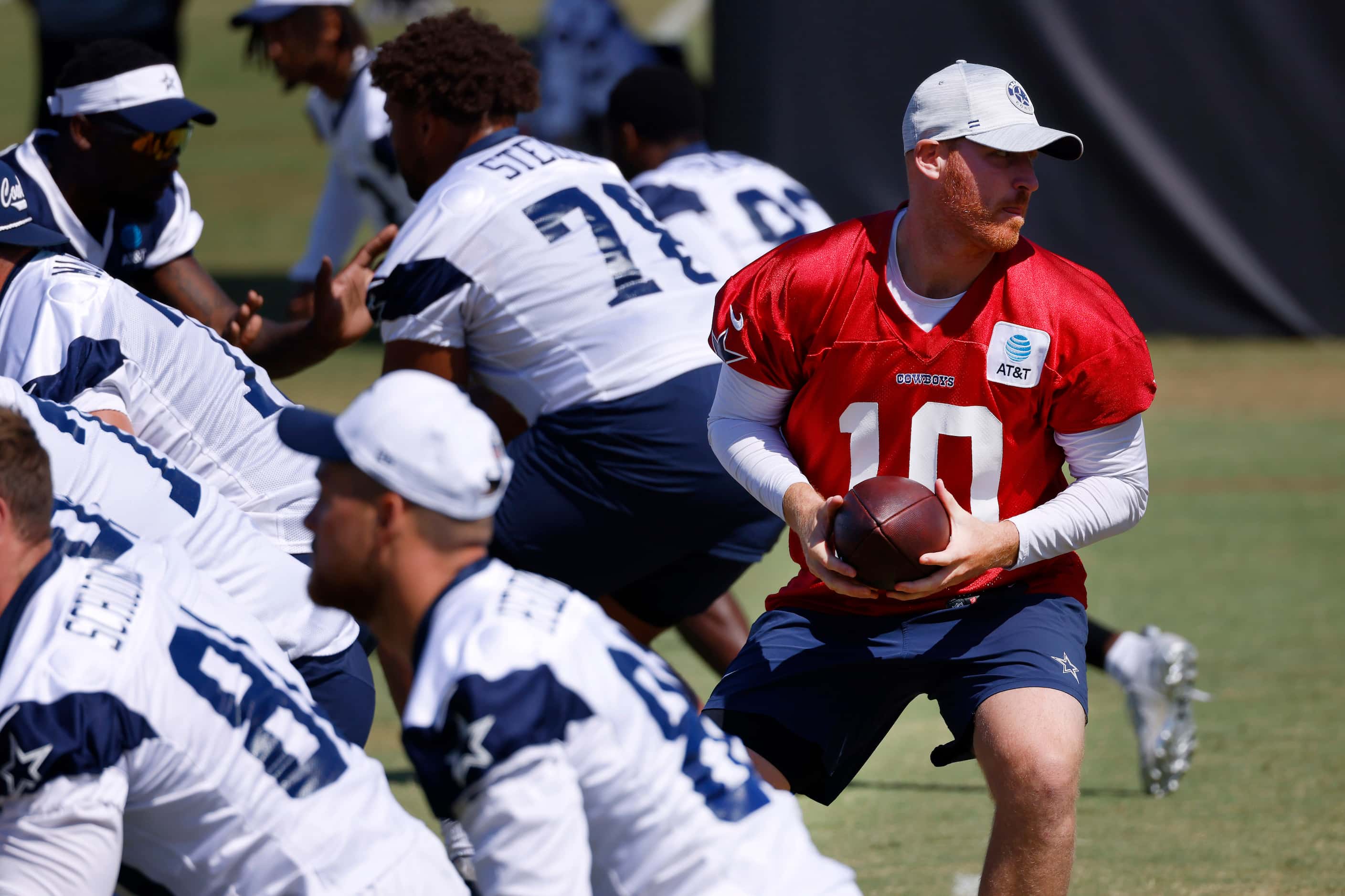 Dallas Cowboys quarterback Cooper Rush (10) takes a snap during a mock game workout in...