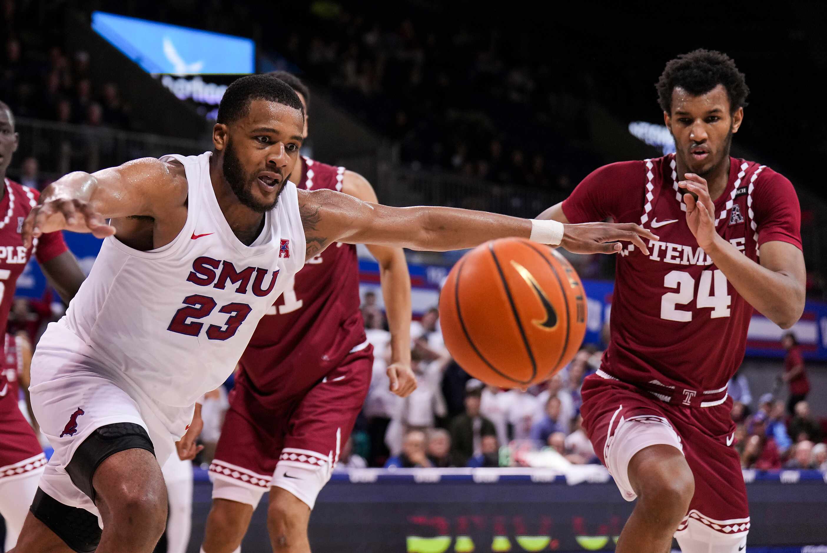 SMU forward Efe Odigie (23) chases a loose ball with Temple forward Zach Hicks (24) during...