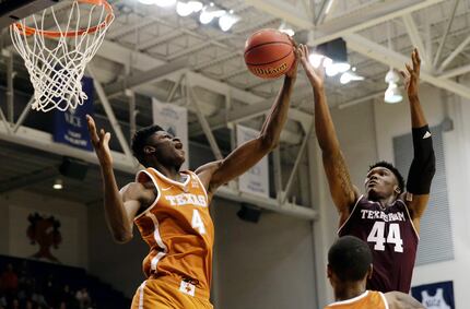 FILE - In this Oct. 25, 2017, file photo, Texas forward Mohamed Bamba (4) grabs a rebound...