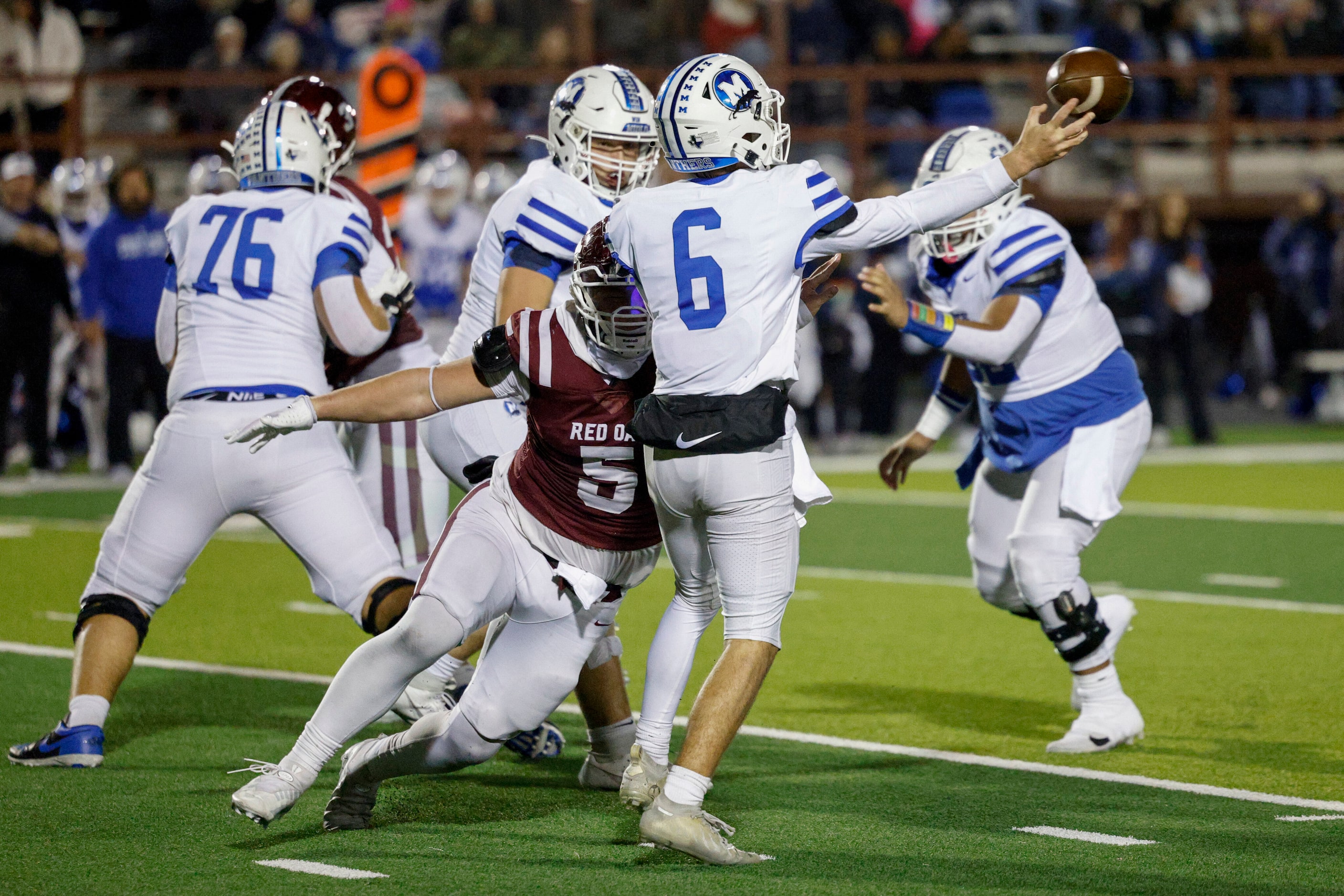 Red Oak defensive end Tanner Thompson (5) hits Midlothian quarterback Colin Shannon (6)...