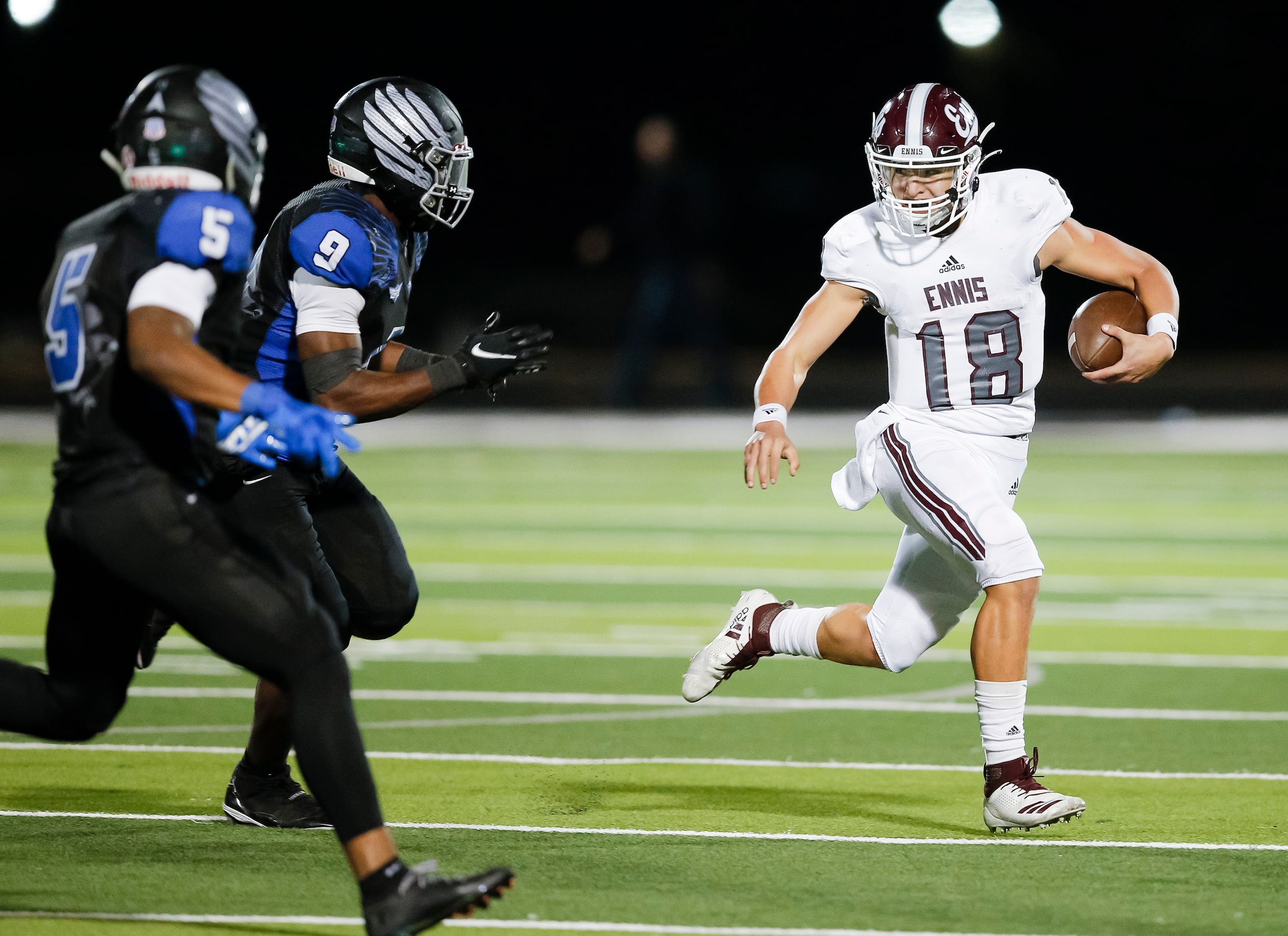 Ennis senior quarterback Collin Drake (18) looks for room against North Forney senior...