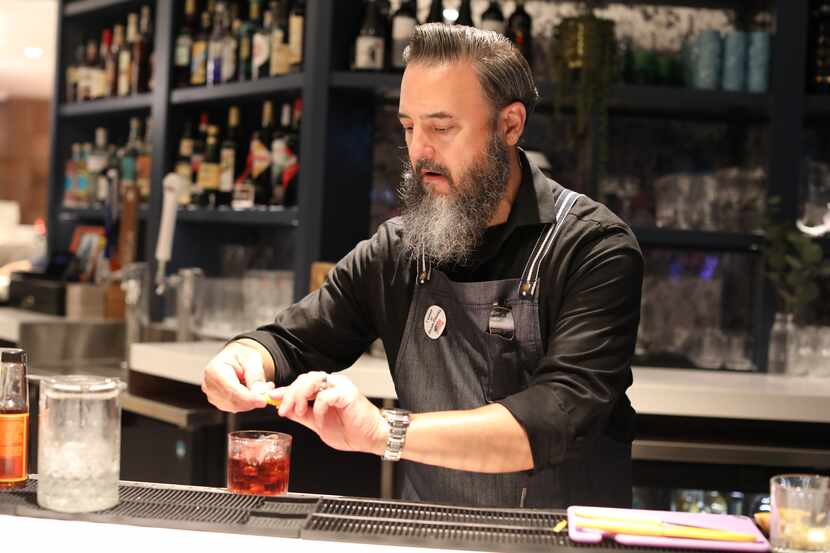 Andrew Kelly makes a negroni at Partenope in Richardson.