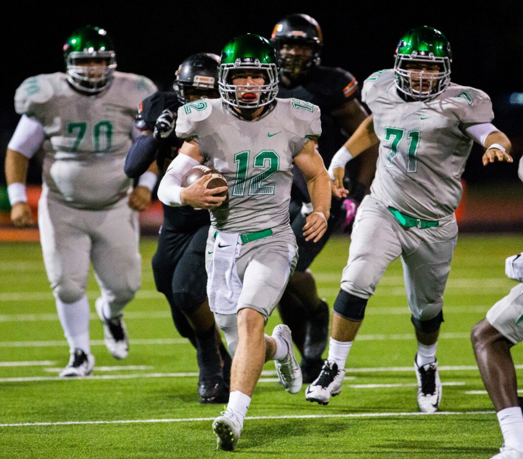 Waxahachie quarterback Bryce Salik (12) runs the ball during the second quarter of their...