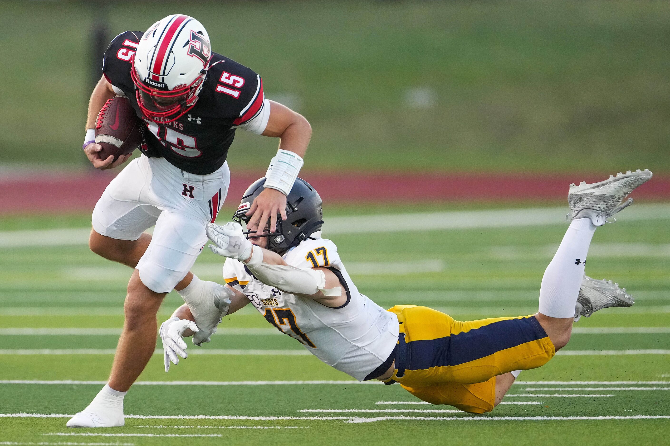 Rockwall-Heath quarterback Landen Dutka (15) gets past Highland Park defensive back Brady...