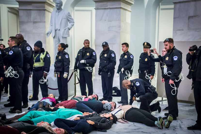 About 70 protesters against the GOP tax bill were arrested Monday while staging a "die-in"...
