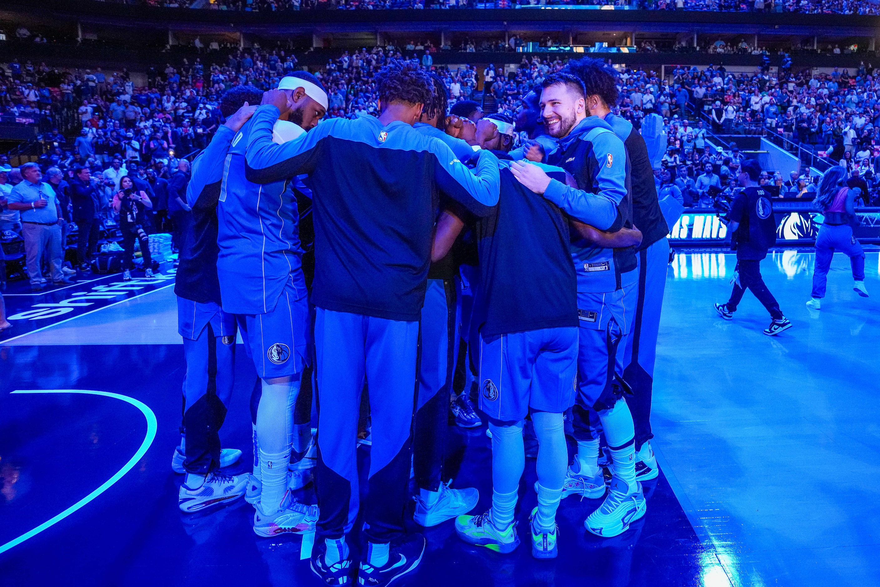 Dallas Mavericks guard Luka Doncic huddles with teammates before an NBA basketball game...