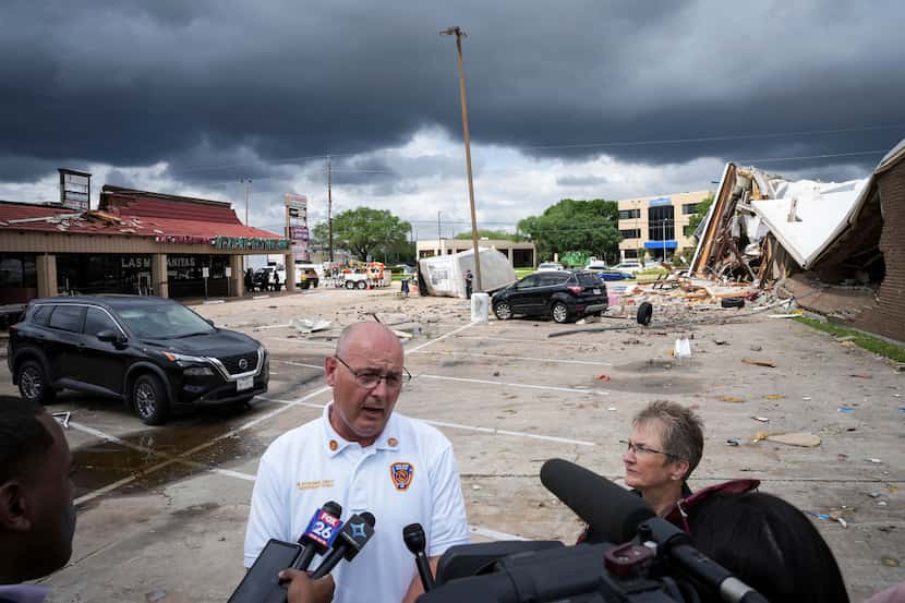 Harris County Emergency Services District Assistant Chief Mark Donovan speaks to reporters...
