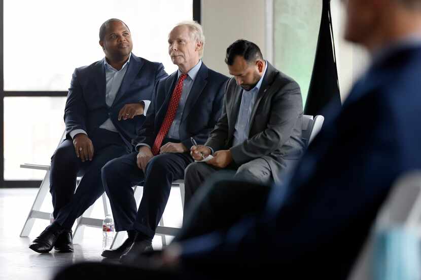 Dallas City Councilman Paul Ridley, center, sits with Mayor Eric Johnson, left, and City...