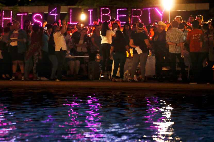 Decenas de personas se reunieron en el centro de Dallas para participar en la vigilia...