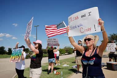 Lori Jordan-Rice (right) of Saginaw, Texas, and others demonstrate outside of Gateway Church...
