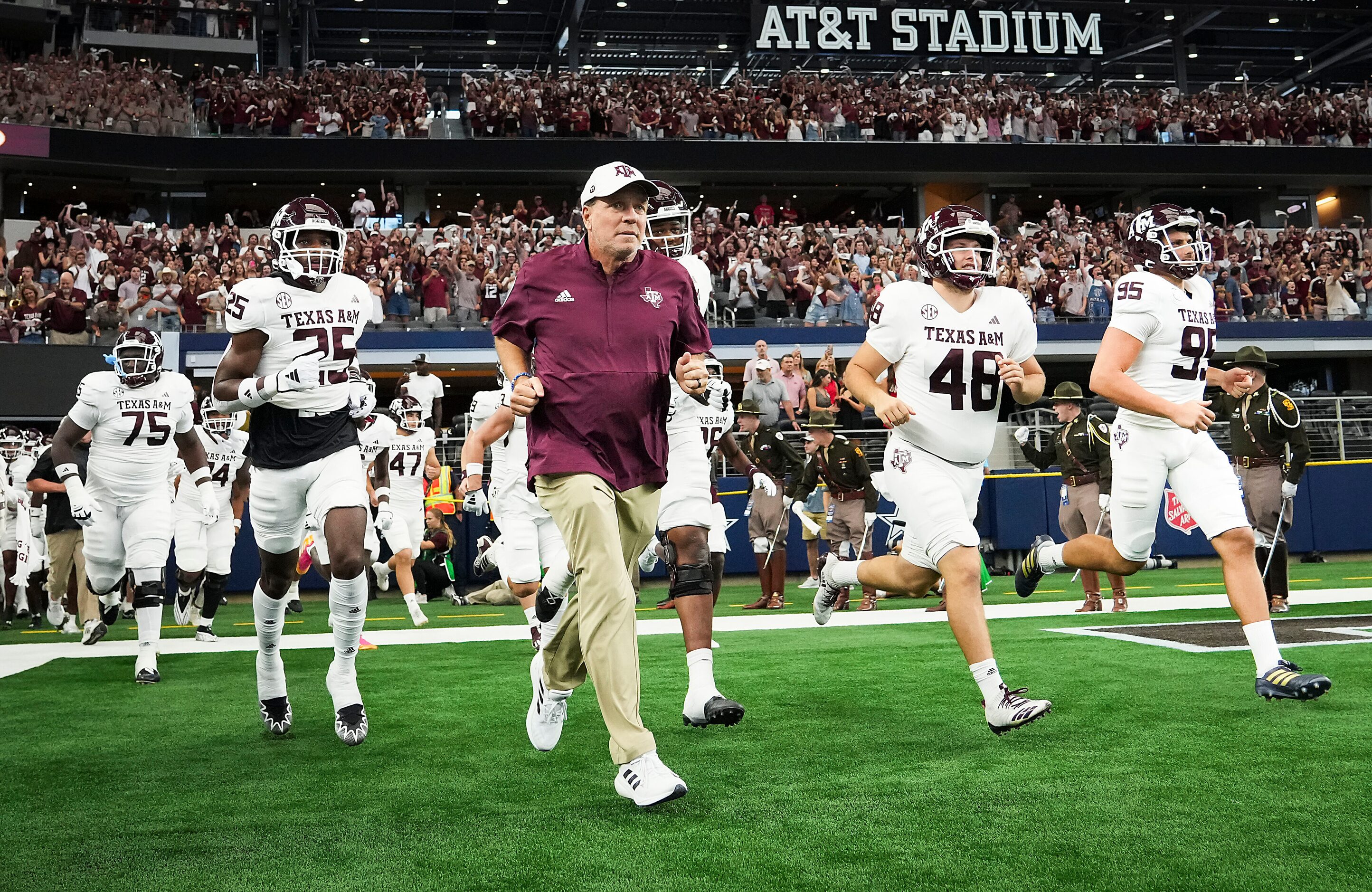 Texas A&M head coach Jimbo Fisher takes the field with his team before an NCAA football game...