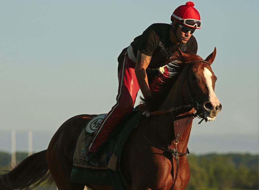 California Chrome, with exercise rider William Delgado up, during an exercise session at...