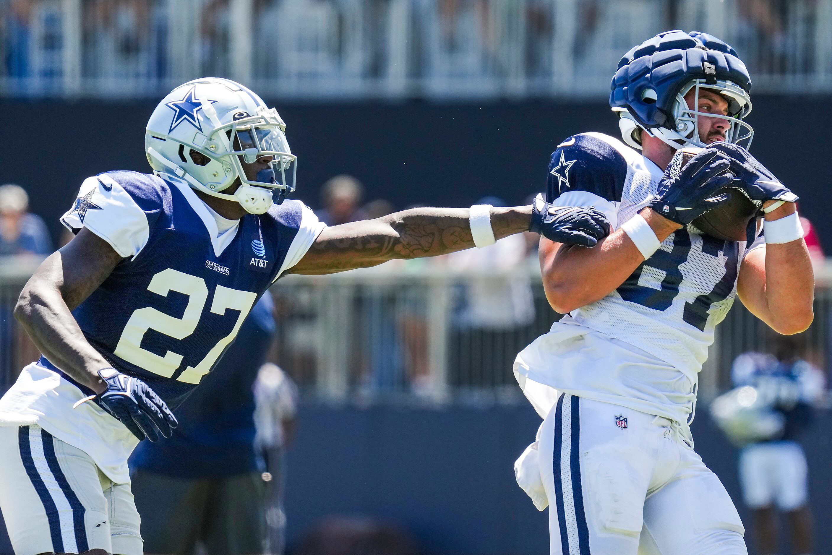 Dallas Cowboys tight end Jake Ferguson (87) catches a pass as safety Jayron Kearse (27)...