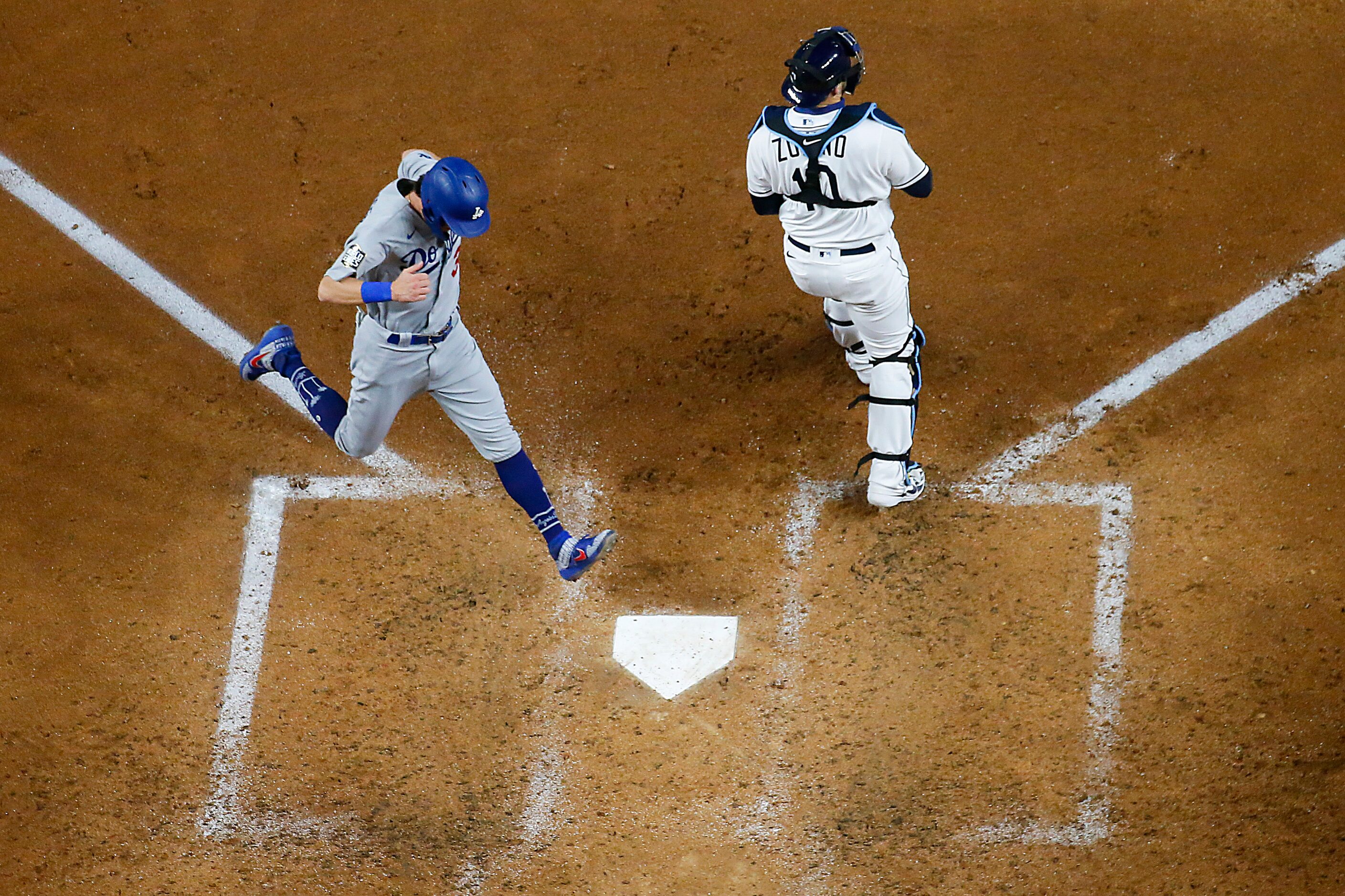 Los Angeles Dodgers center fielder Cody Bellinger scores from third base past Tampa Bay Rays...