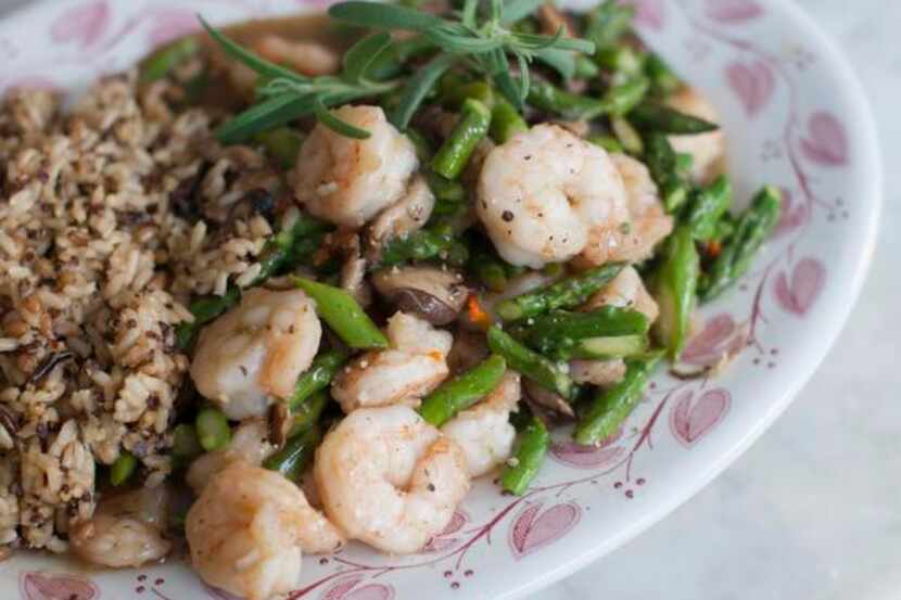 
This March 31, 2014 photo shows pan seared asparagus with shrimp, shiitakes, and chilies in...