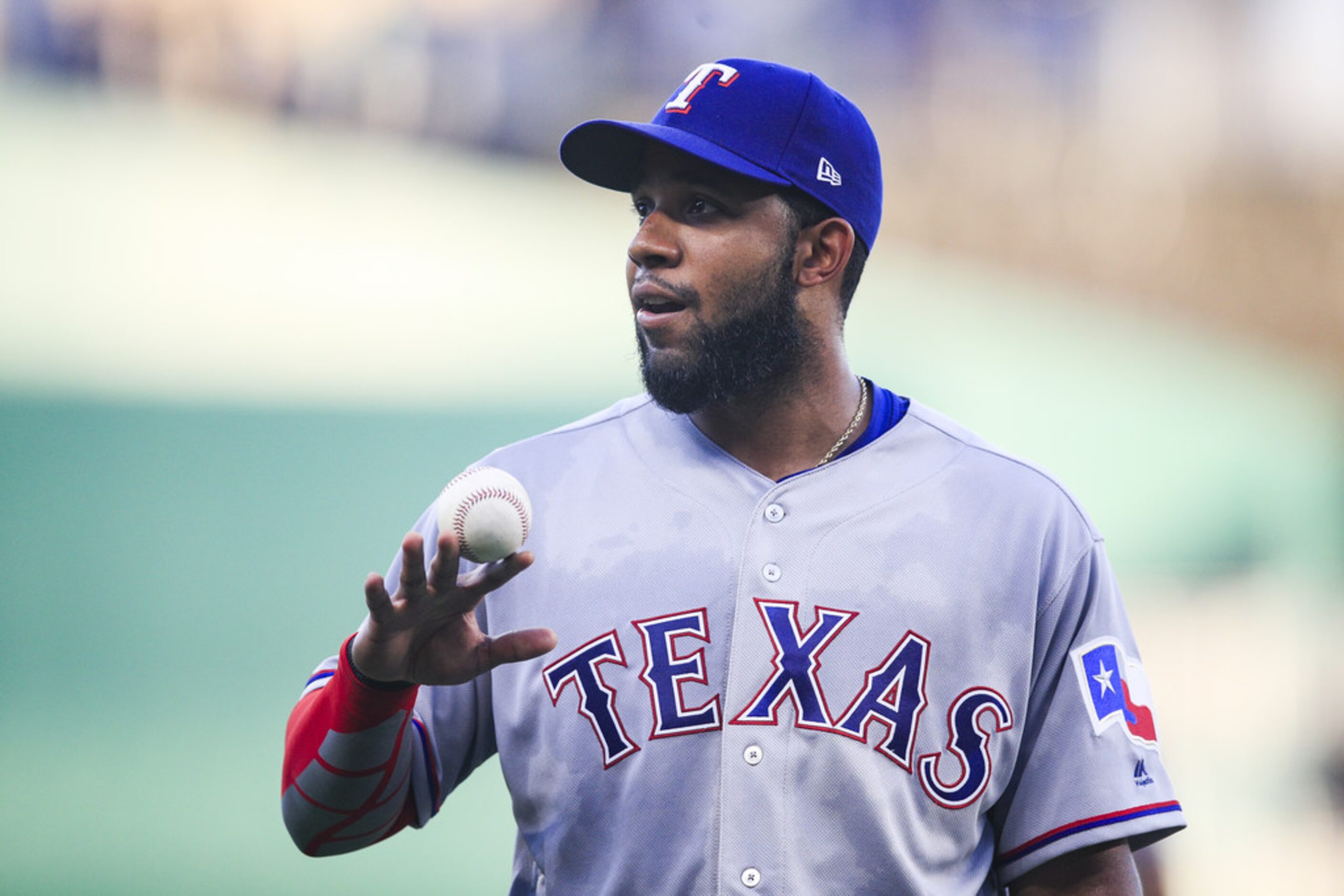 KANSAS CITY, MO - JUNE 18: Elvis Andrus #1 of the Texas Rangers walks off the field after...