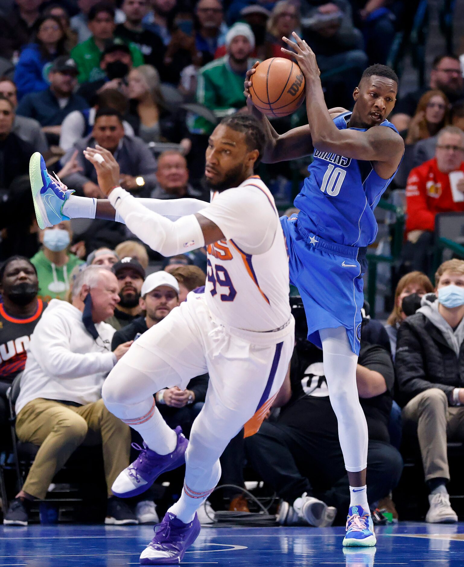 Dallas Mavericks forward Dorian Finney-Smith (10) comes down with a defensive rebound behind...