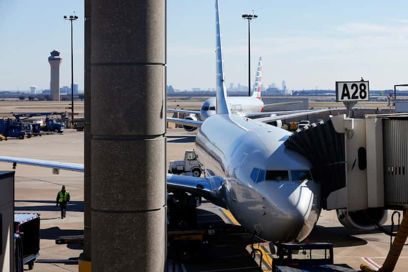 An American Airlines plane is parked at a Terminal A gate at Dallas-Fort Worth International...