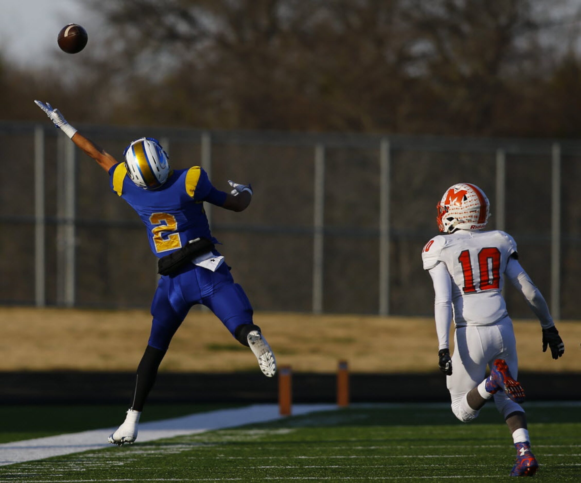 TXHSFB Sunnyvale's Lawson Ayo (C) (2) stretches but is unable to come up with the ball as...