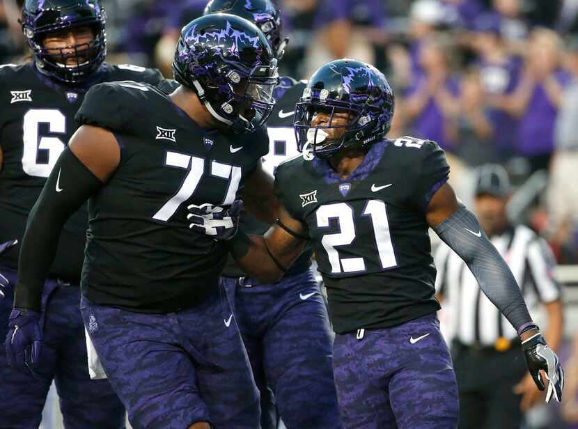 TCU's Lucas Niang (77) and running back Kyle Hicks (21) celebrate Hicks' touchdown during...