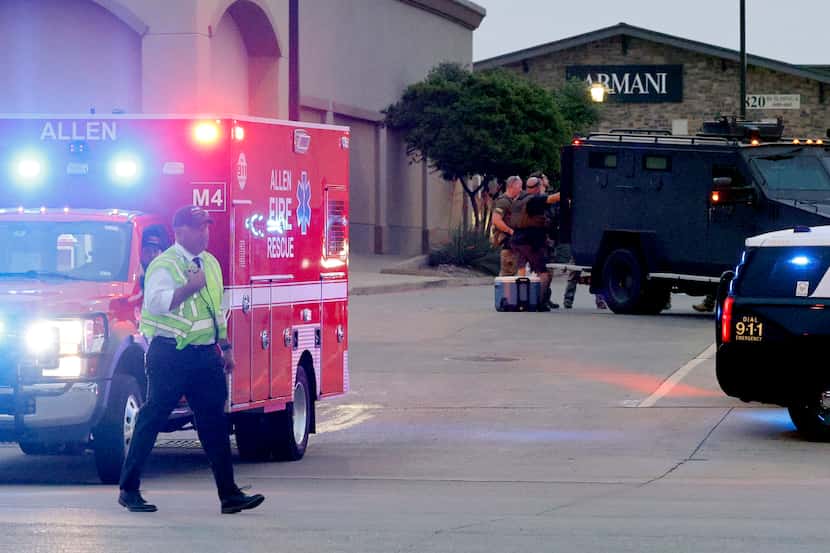 An Allen Fire Rescue ambulance leaves the scene after a mass shooting at the Allen Premium...