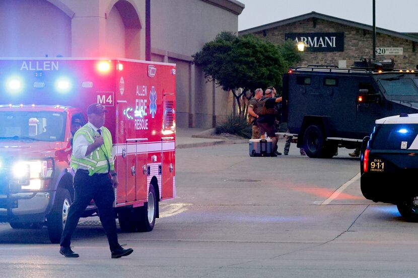 An Allen Fire Rescue ambulance leaves the scene after a mass shooting at the Allen Premium...