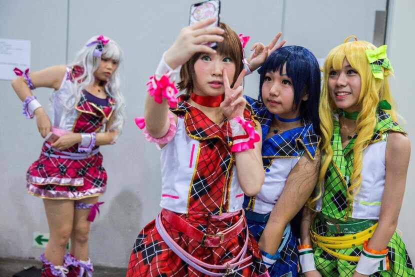 Cosplay fans take selfies as comic book and gaming fans attend the annual Ani-Com and Games...