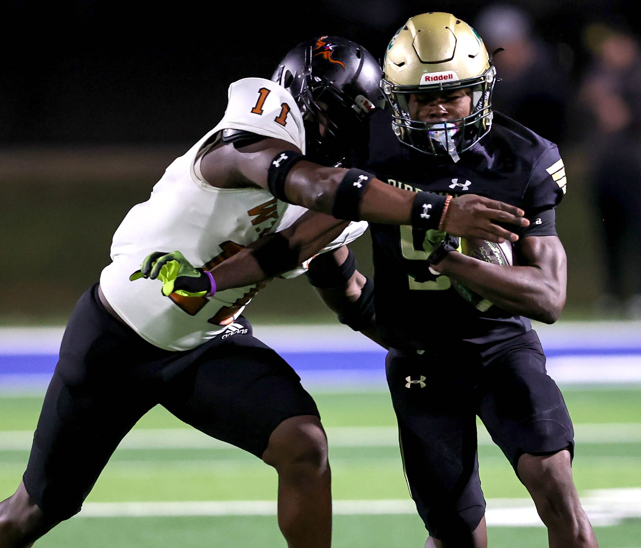 Birdville wide receiver Brian Kent (9) fights his way past W.T. White linebacker Markavious...