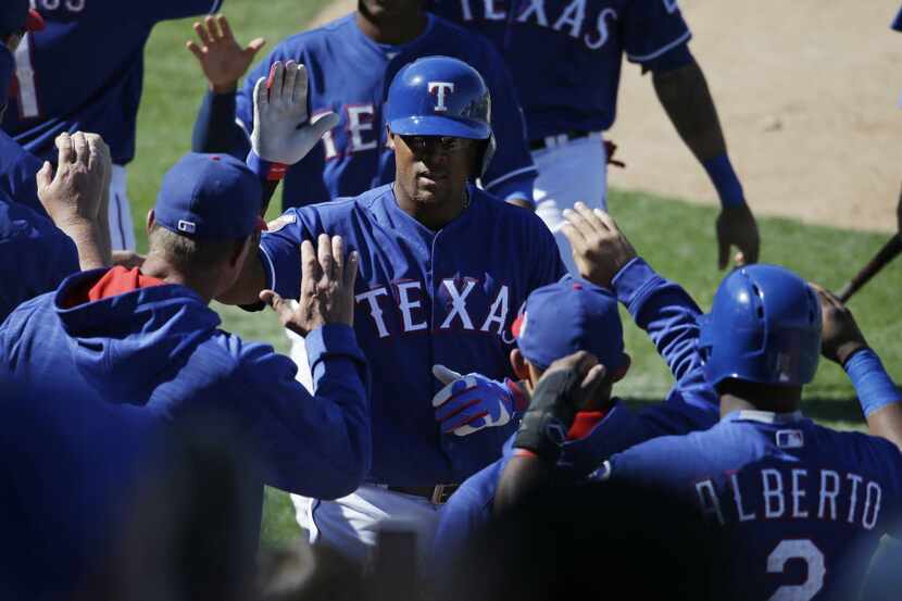 Texas Rangers' Adrian Beltre, center, celebrates with teammates after hitting a three-run...