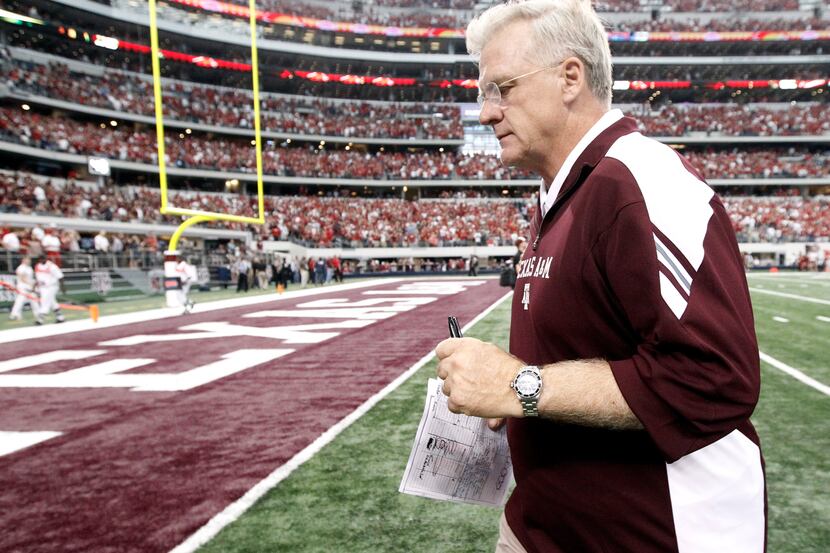 Texas A&M head coach Mike Sherman leaves the field after losing to Arkansas 42-38 in an NCAA...