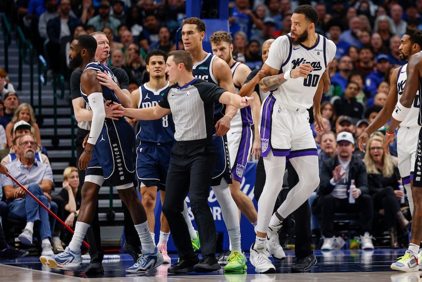 Dallas Mavericks forward Tim Hardaway Jr. (10) and Sacramento Kings center JaVale McGee (00)...