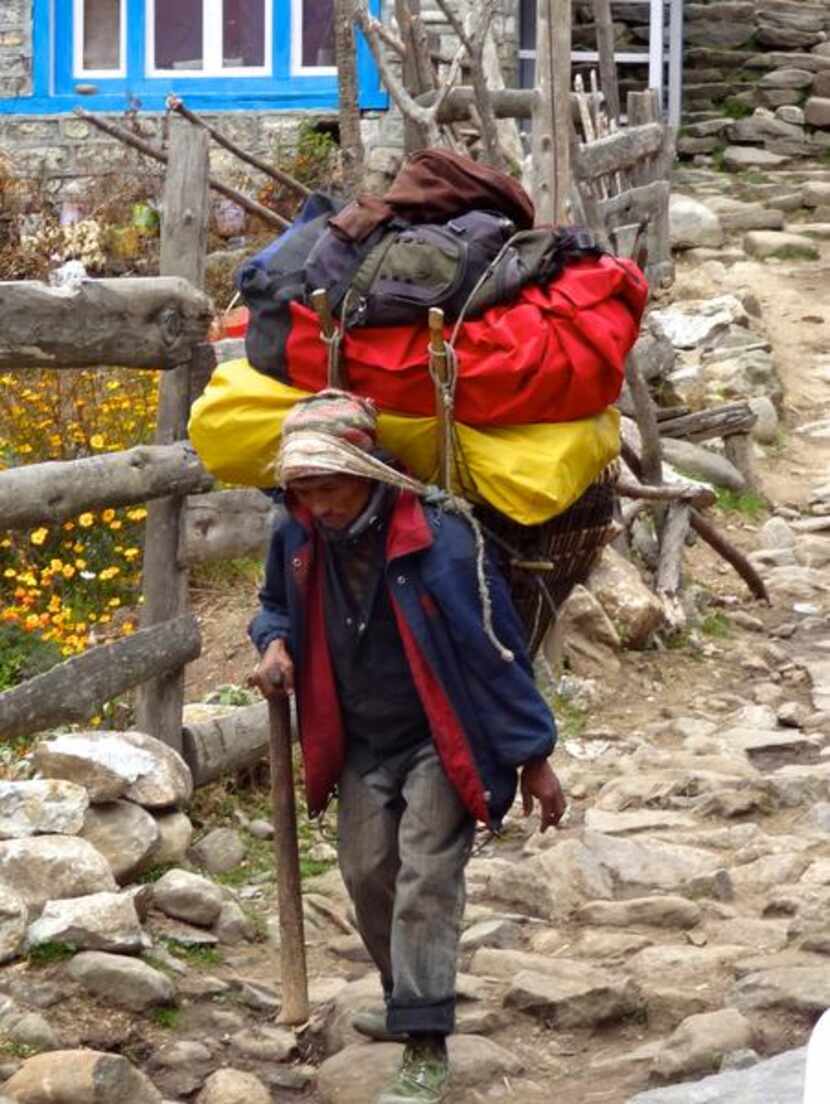 
A porter carrying gear for trekkers on the trail to Mount Everest. A standard porter load...