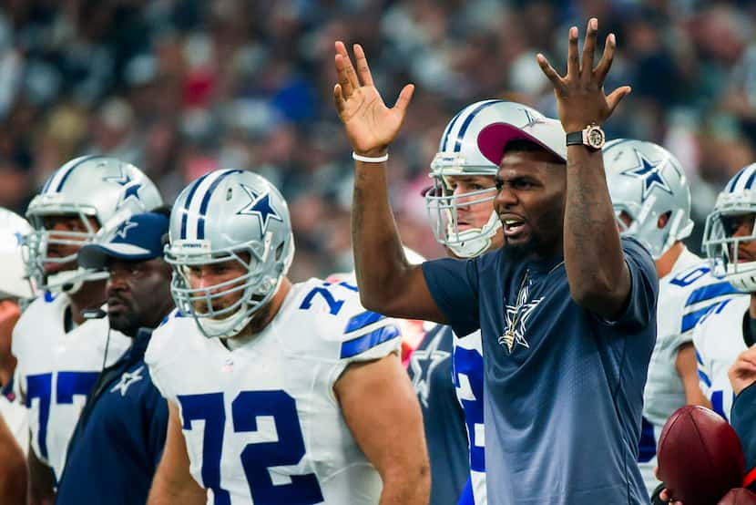 Dallas Cowboys wide receiver Dez Bryant reacts to a play as he watches from the sidelines...