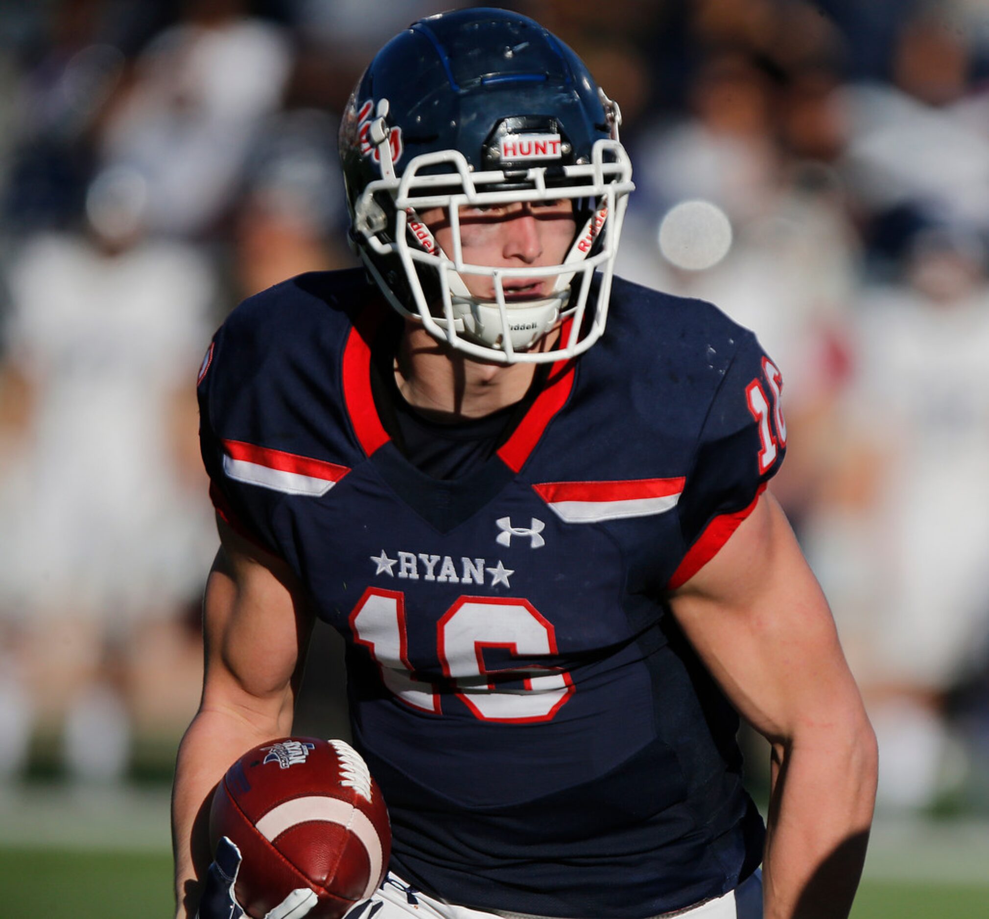 Denton Ryan High School wide receiver Drew Sanders (16) carries the football on his way to...