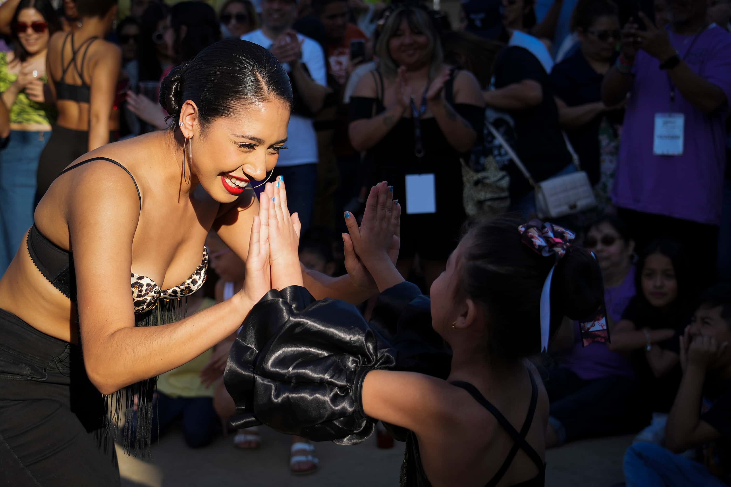 Olly Cruz (left) high fives Elizabeth Rodriguez after they were named finalists in a Selena...
