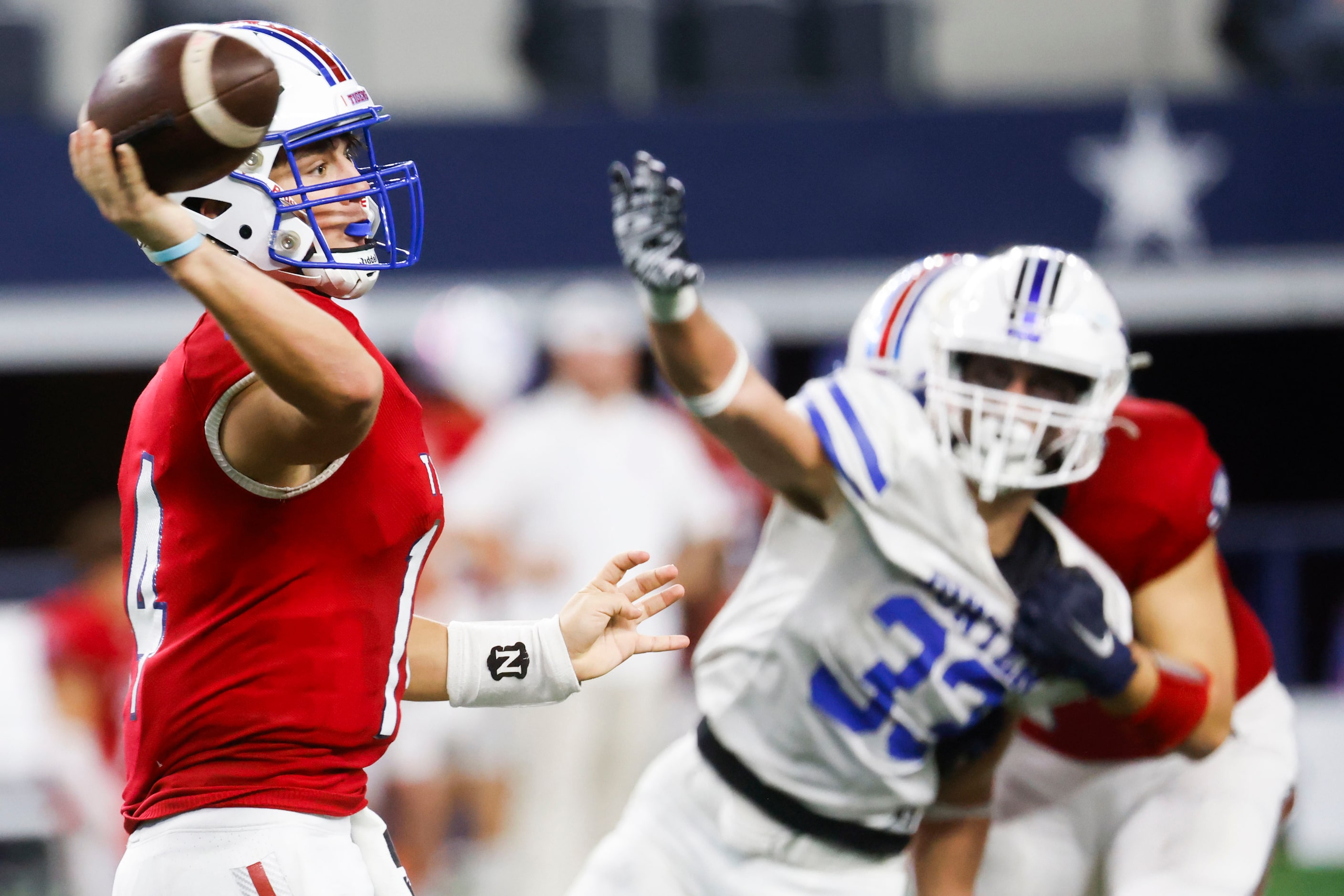 El Maton Tidehaven QB Kevin Rickaway (left) throws as Gunter High’s Hayden Farrell reaches...