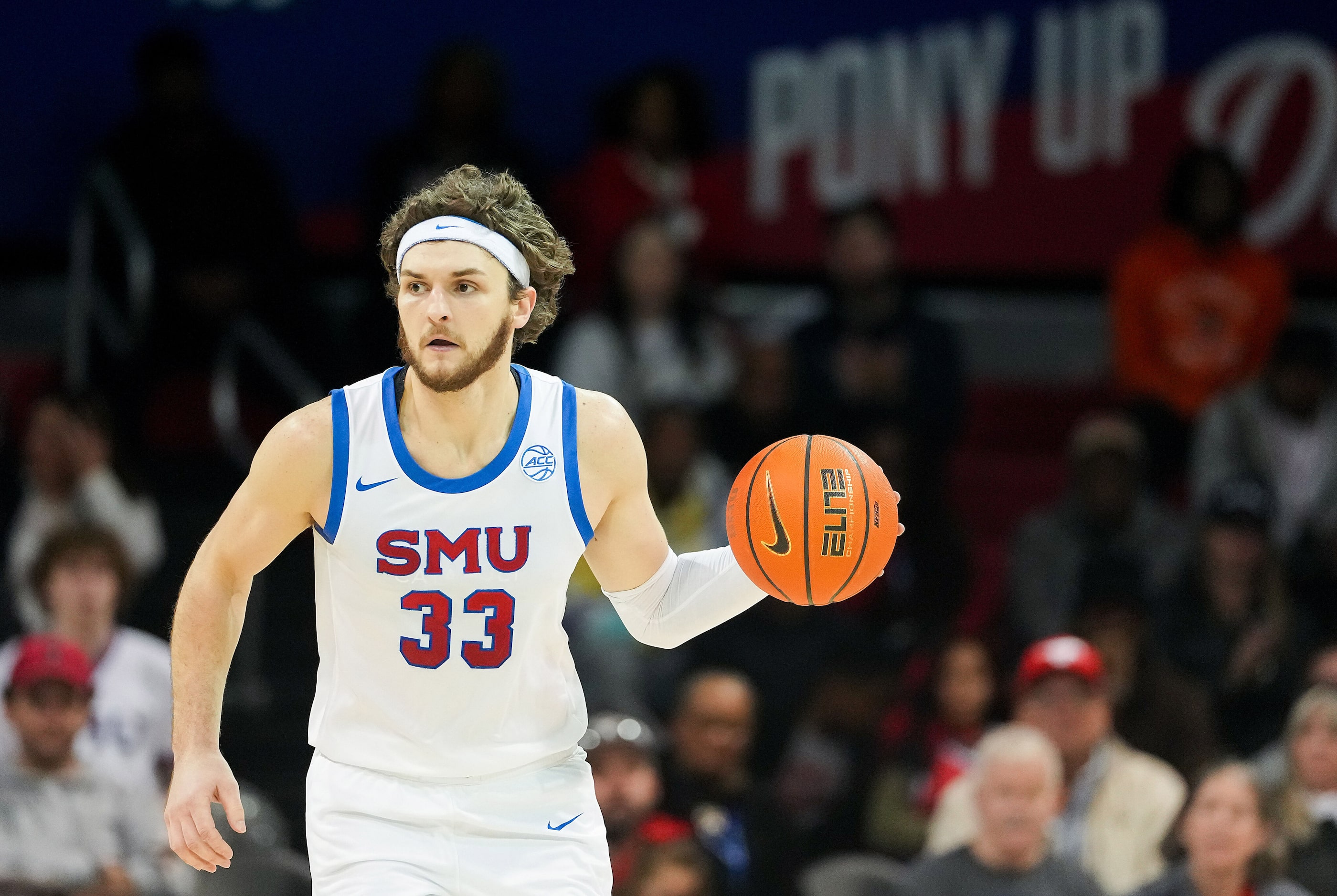 SMU forward Matt Cross (33) brings the ball up the court during the first half of an NCAA...